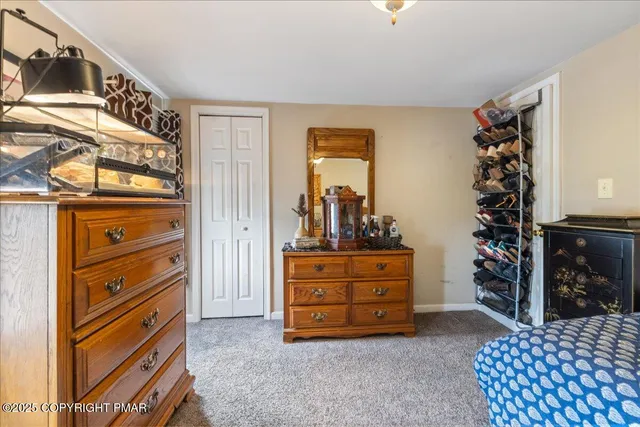 a bedroom with furniture and a wooden floor
