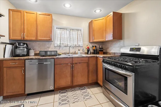 a kitchen with a sink stove top oven and cabinets