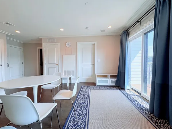 a living room with furniture a rug and a window