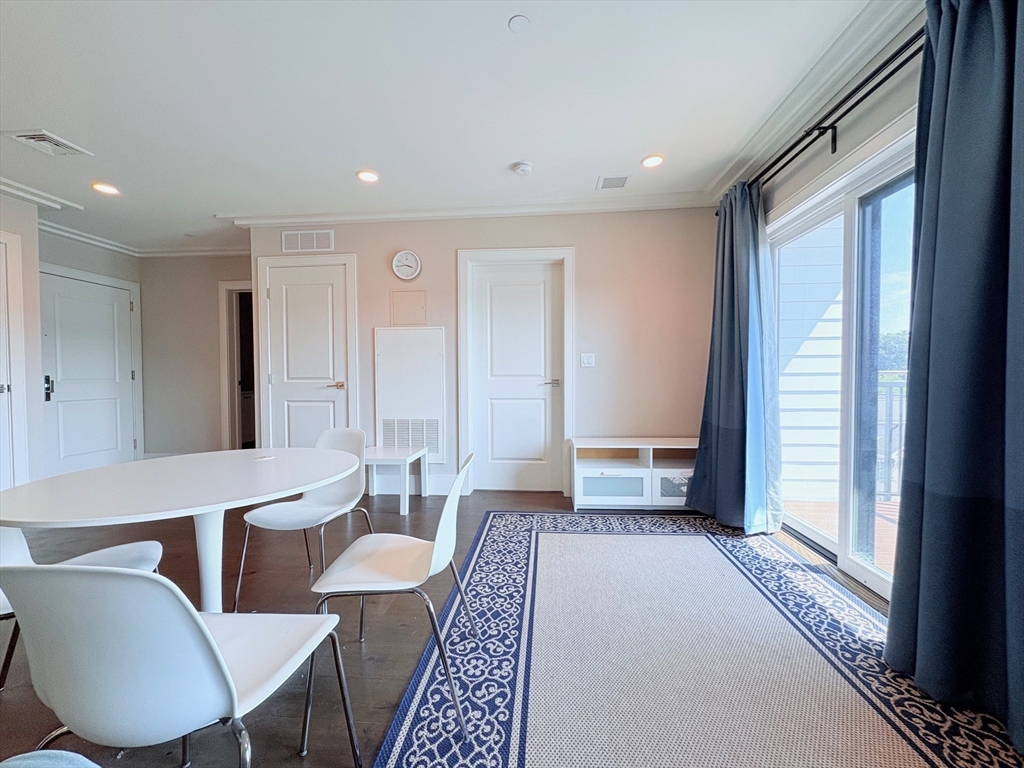 214 Market Street, Unit 405 Boston, MA 02135 - Photo 12 of 22 a living room with furniture a rug and a window