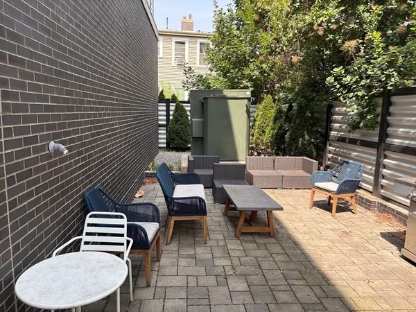 a backyard of a house with table and chairs