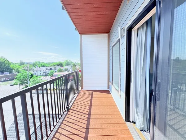 a view of balcony with wooden floor