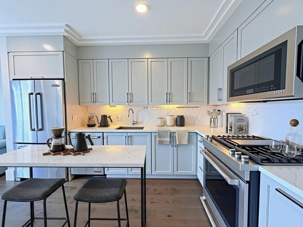 214 Market Street, Unit 405 Boston, MA 02135 - Photo 5 of 22 a kitchen with a stove and a microwave