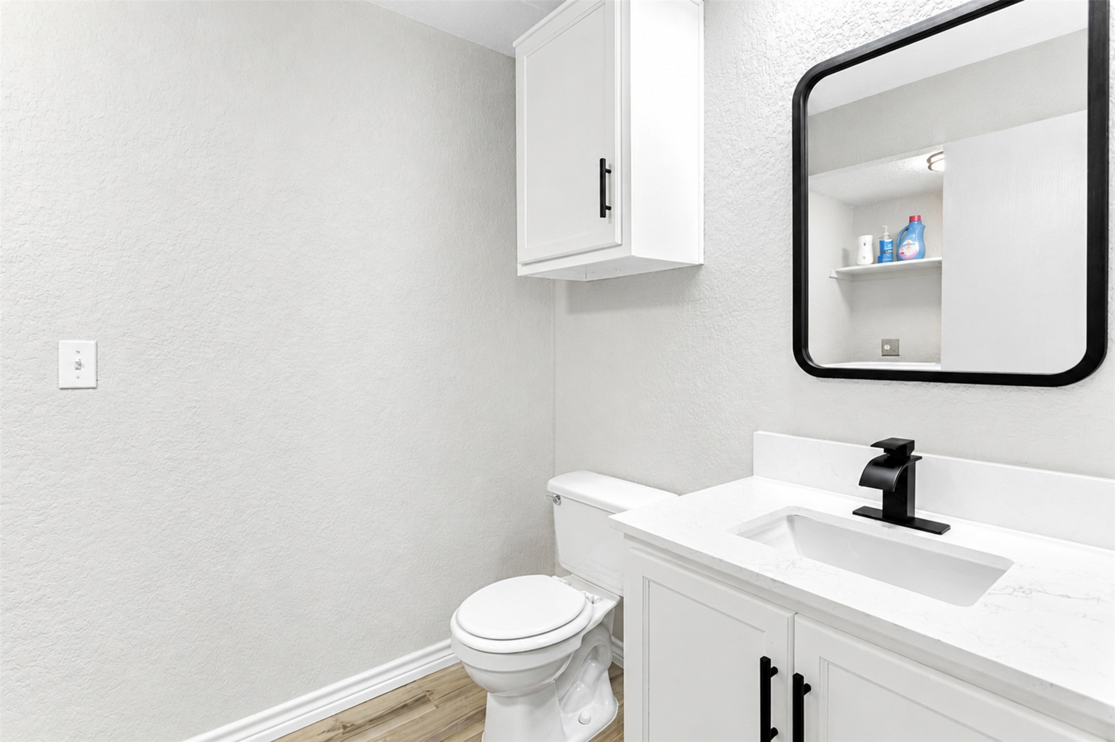 4523 Secure Lane Austin, TX 78725 - Photo 21 of 40 Modern design elements enhance this well-appointed bathroom vanity with sleek fixtures.