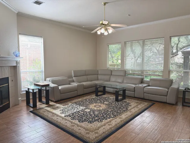 a living room with furniture a fireplace and a flat screen tv