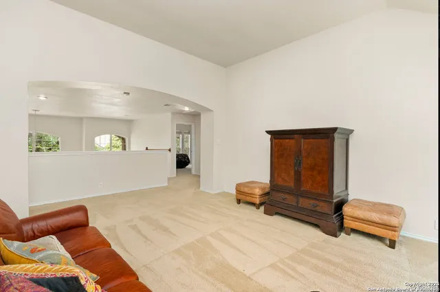 a spacious bedroom with a bed and a large window