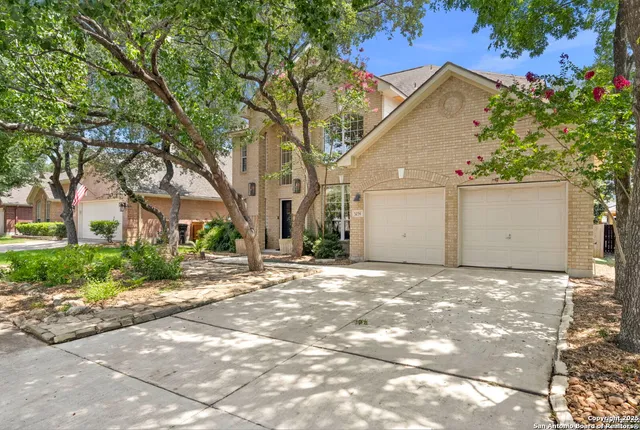 a view of a house with a yard and a garage