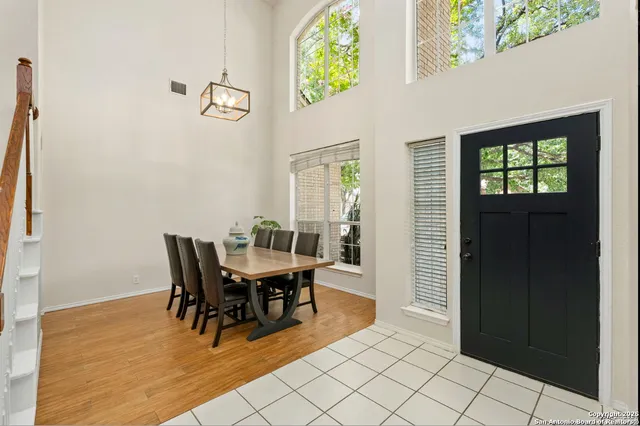 a view of a dining room with furniture and a potted plant