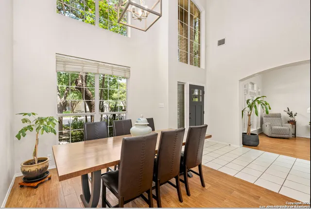 a living room with furniture a fireplace and a floor to ceiling window
