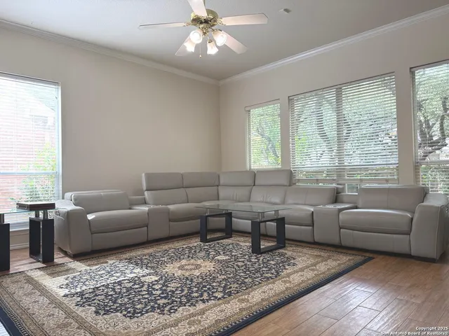 a living room with furniture a chandelier and a fireplace