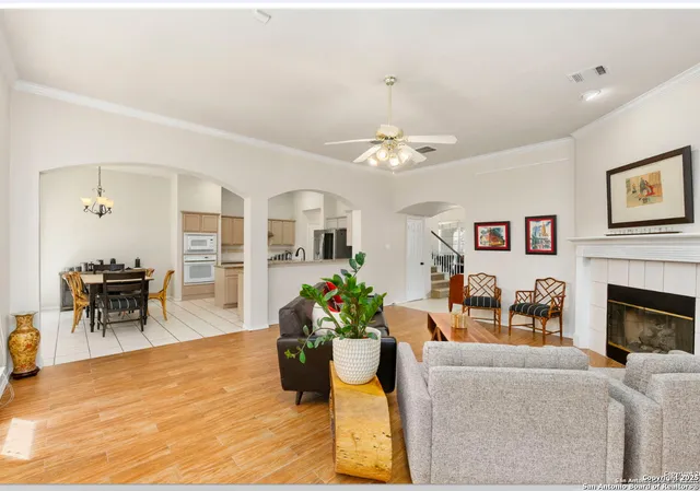 a living room with furniture a flat screen tv and a fireplace