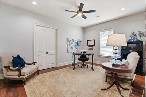 a living room with furniture and a wooden floor