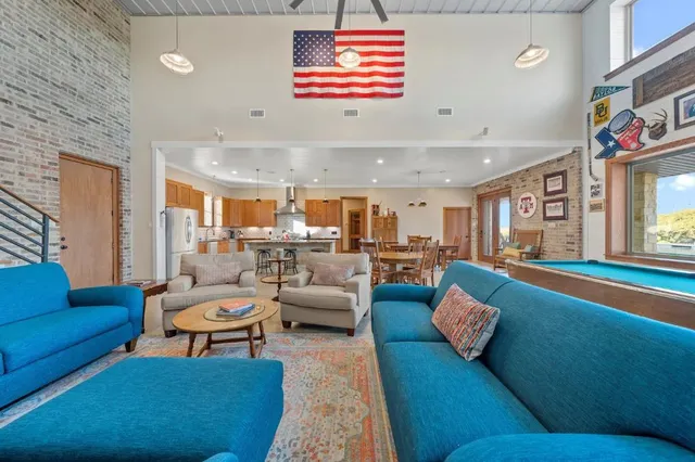 a living room with furniture and kitchen view