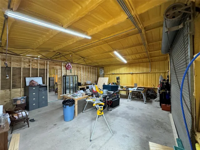a living room with furniture and a air conditioner vent