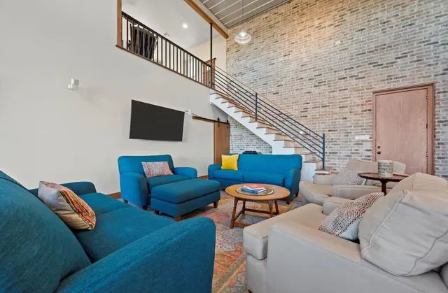 a kitchen with stainless steel appliances granite countertop a stove and a dining table