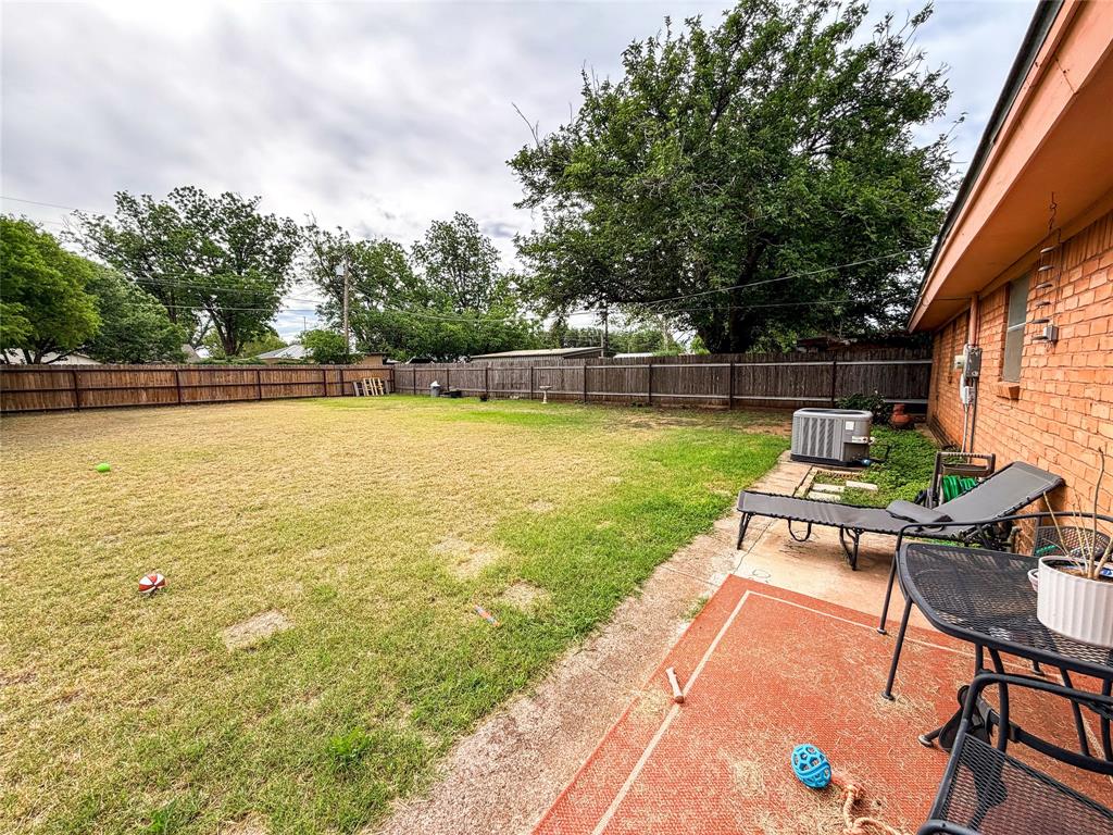 1706 North Ave H Haskell, TX 79521 - Photo 24 of 25 a view of a swimming pool with a table and chairs under an umbrella