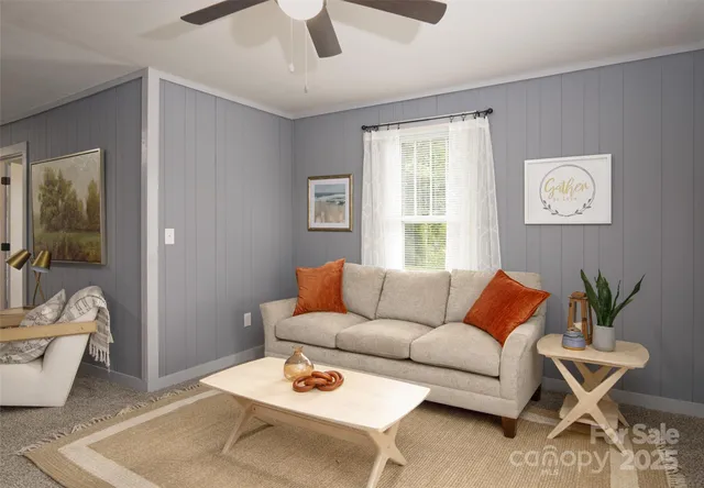 a living room with furniture and a potted plant