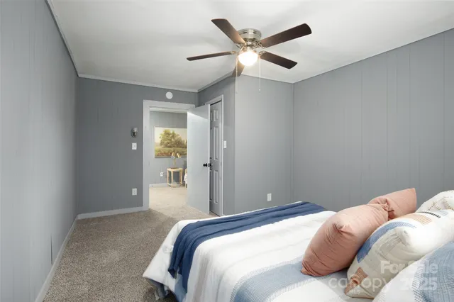 a bedroom with a large bed and a chandelier