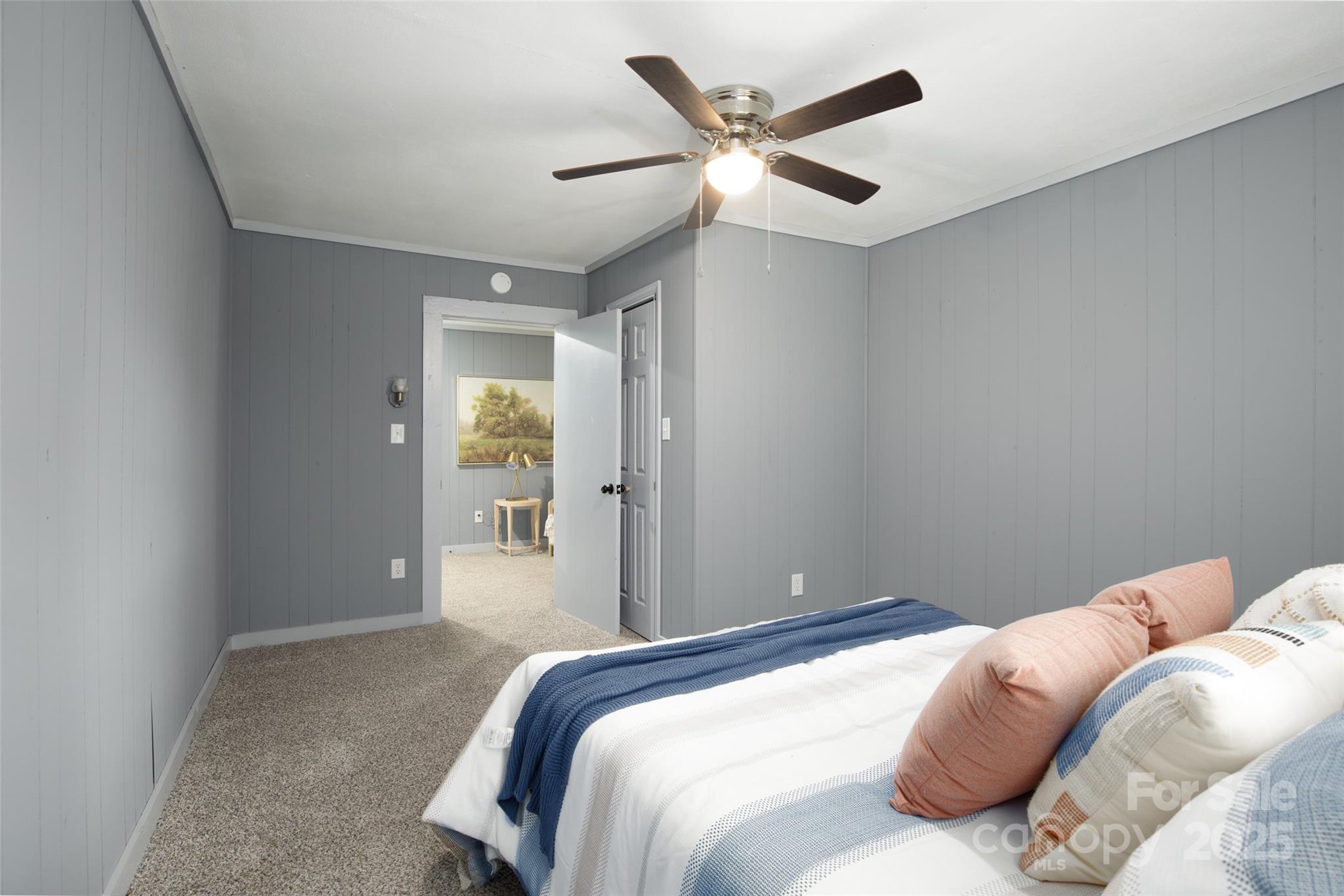 2326 Morganton Boulevard Southwest Lenoir, NC 28645 - Photo 13 of 34 a bedroom with a large bed and a chandelier