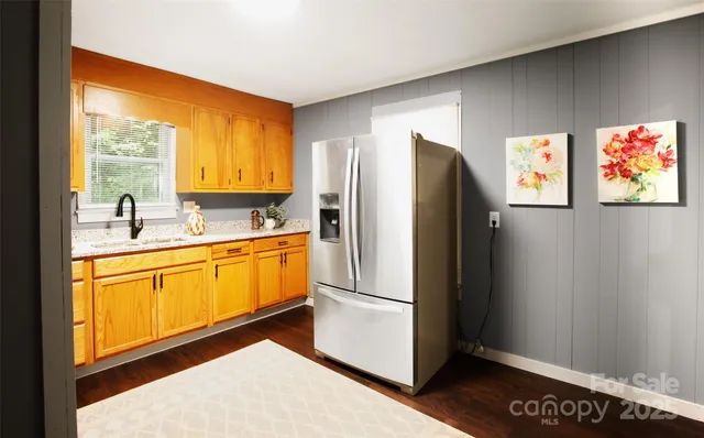 a kitchen with stainless steel appliances a refrigerator and a sink