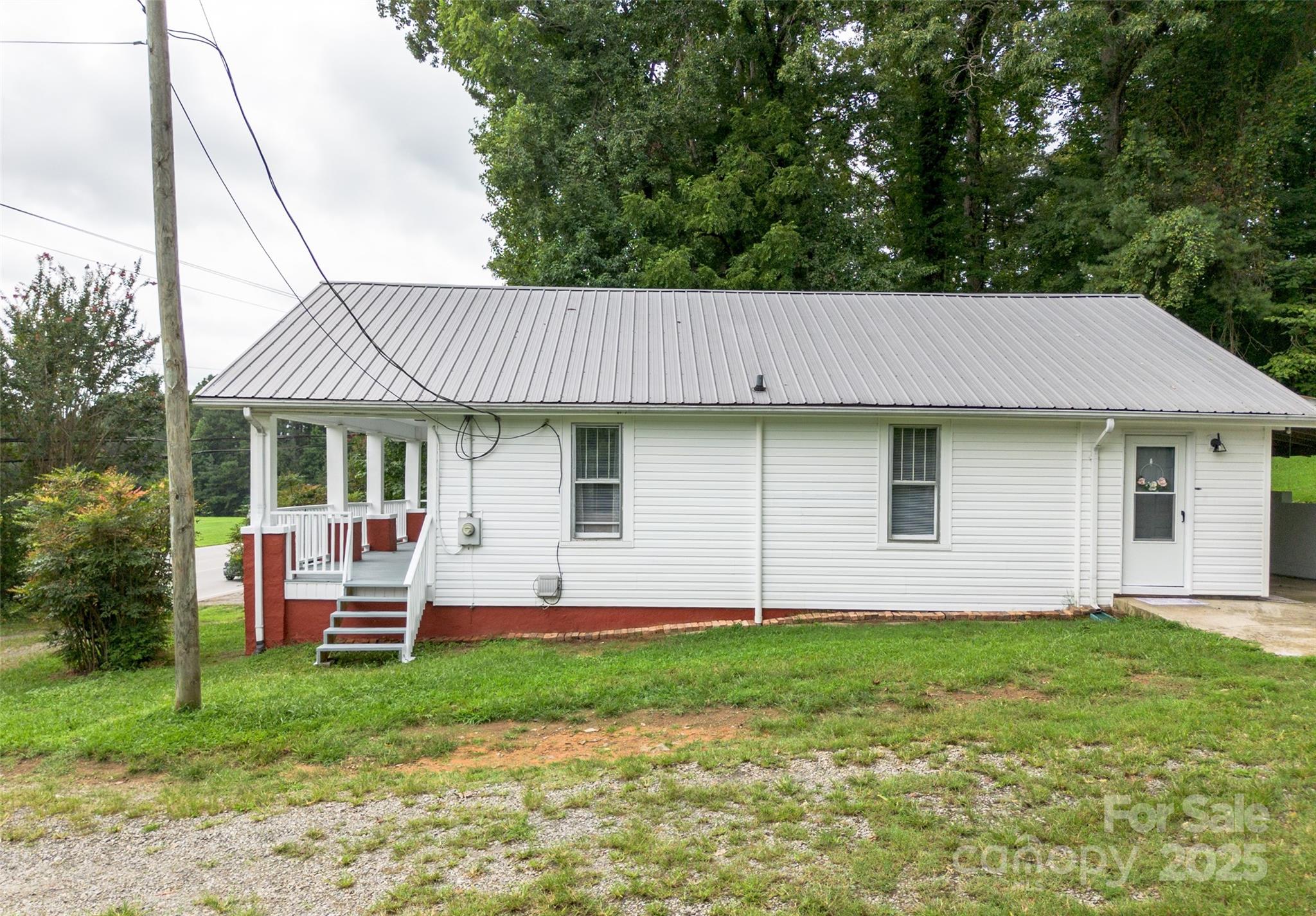 2326 Morganton Boulevard Southwest Lenoir, NC 28645 - Photo 24 of 34 a front view of a house with a garden and porch