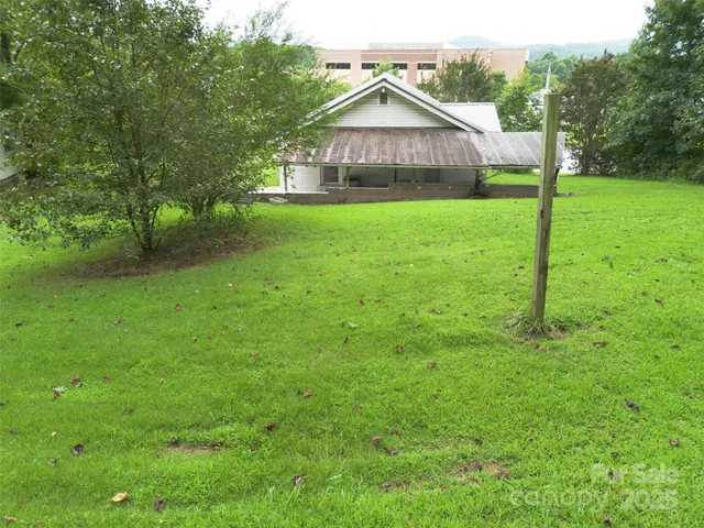 a aerial view of a house with a yard table and chairs