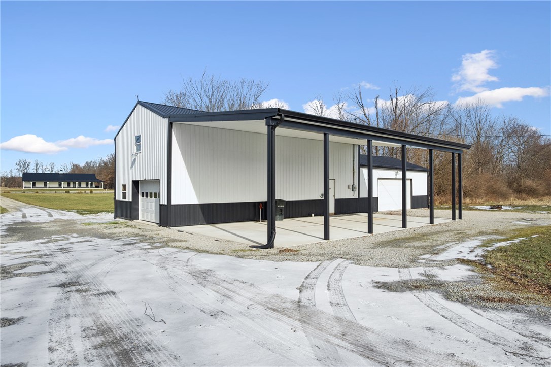 1602 Westboro Road Blanchester, OH 45107 - Photo 44 of 81 This spacious barn with an attached covered carport offers versatile utility and ample storage.
