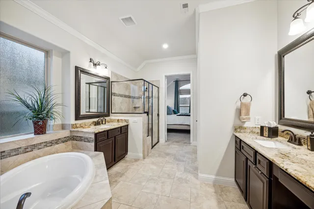 a spacious bathroom with a granite countertop tub sink and mirror