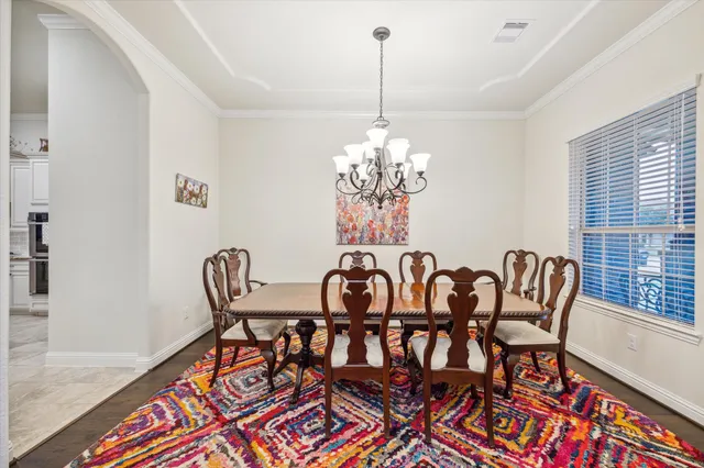 a view of a dining room with furniture and chandelier