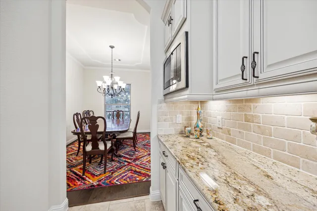 a dining room with furniture and a chandelier