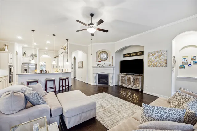 a living room with furniture a flat screen tv and a fireplace