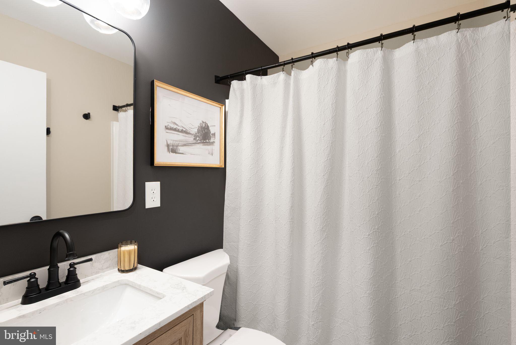12412 Needle Drive Clarksburg, MD 20871 - Photo 23 of 51 a bathroom with a sink and a mirror
