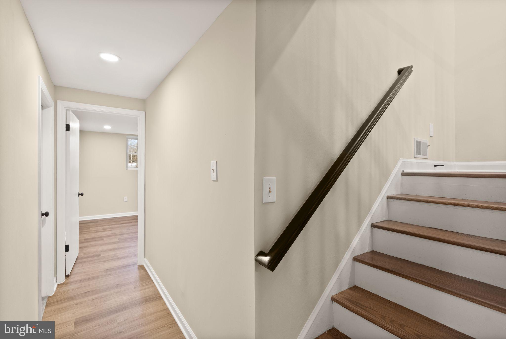 12412 Needle Drive Clarksburg, MD 20871 - Photo 24 of 51 a view of staircase with wooden floor and white walls