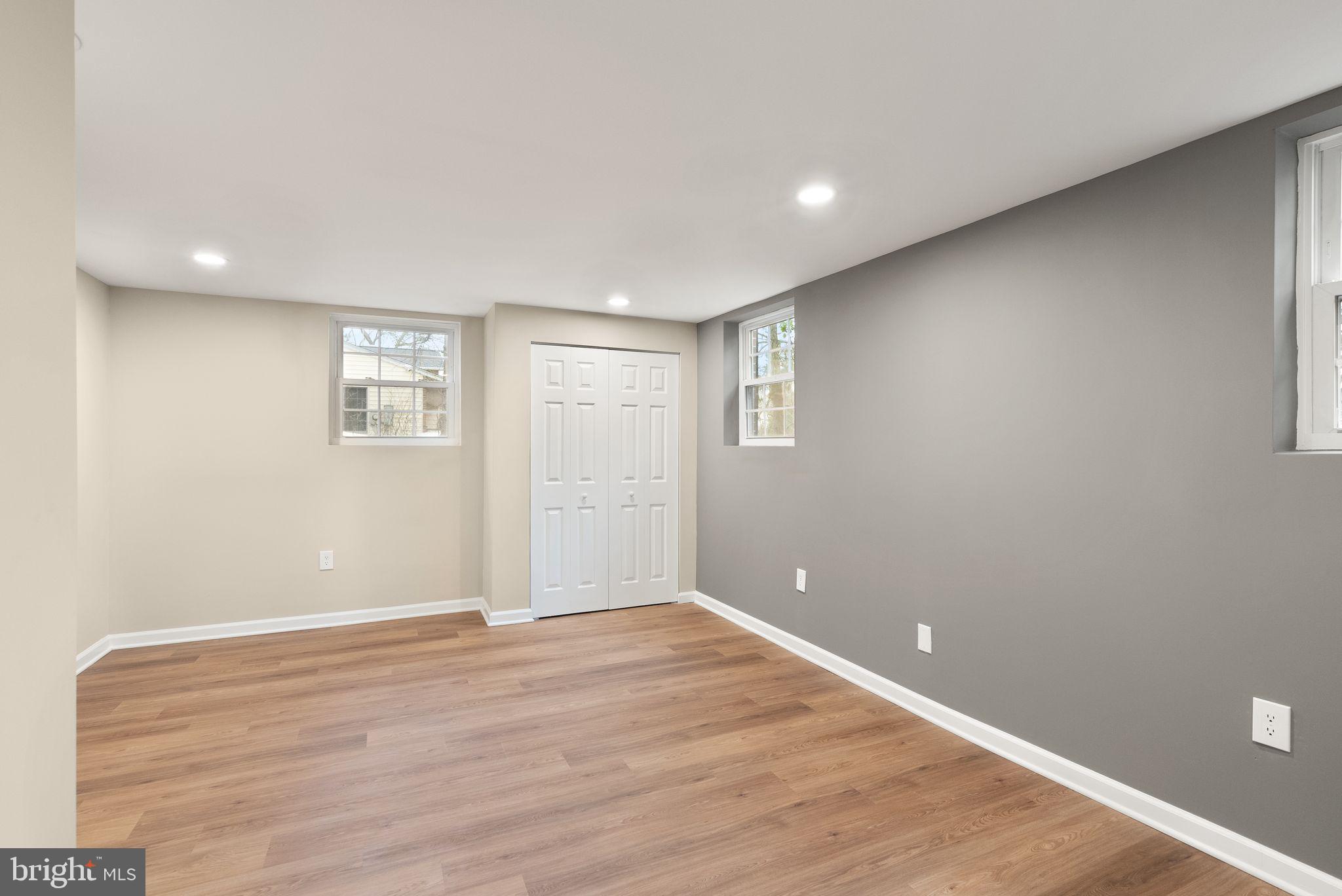 12412 Needle Drive Clarksburg, MD 20871 - Photo 37 of 51 a view of an empty room with wooden floor and a window