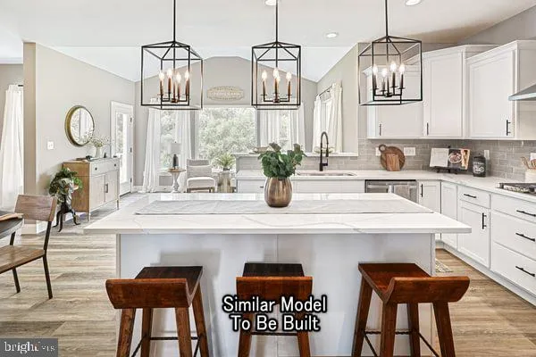 a kitchen with stainless steel appliances a table chairs and a refrigerator