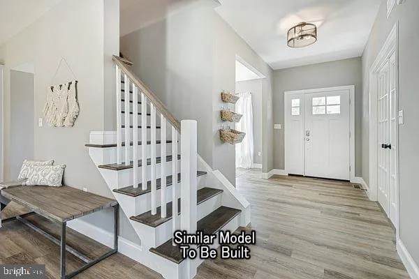 a view of entryway with stairs and wooden floor