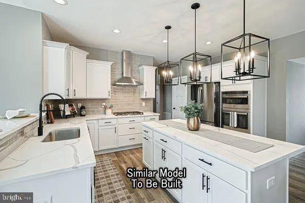 a kitchen with stainless steel appliances kitchen island granite countertop a sink a stove and a refrigerator
