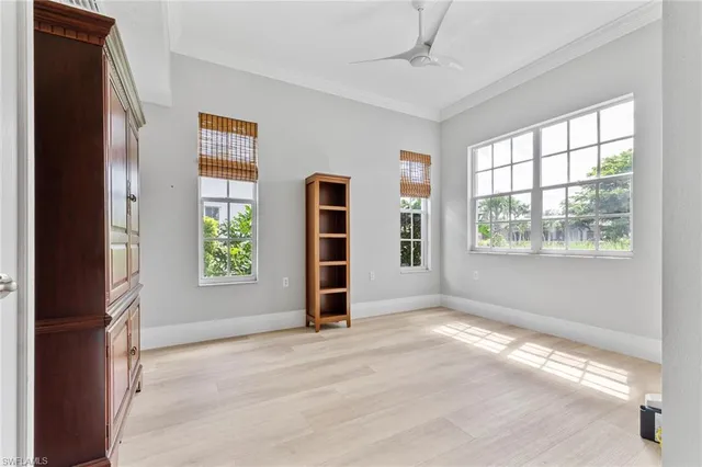 an empty room with windows and closet