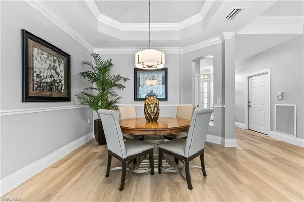 a living room with furniture a table a potted plant and a fireplace
