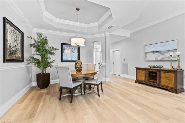 a living room with furniture a rug and a chandelier
