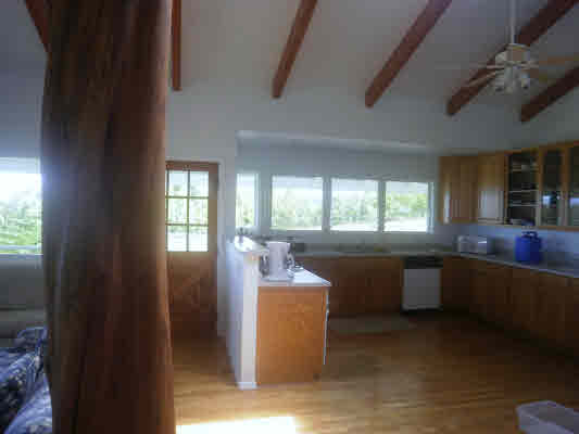 28-70 Kaiwiki Road Hilo, HI 96720 - Photo 6 of 19 a room with kitchen island granite countertop furniture a sink a window and stainless steel appliances