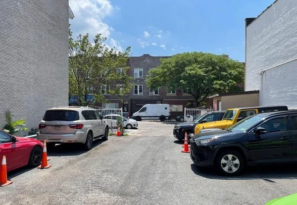 a view of a cars park in front of a building