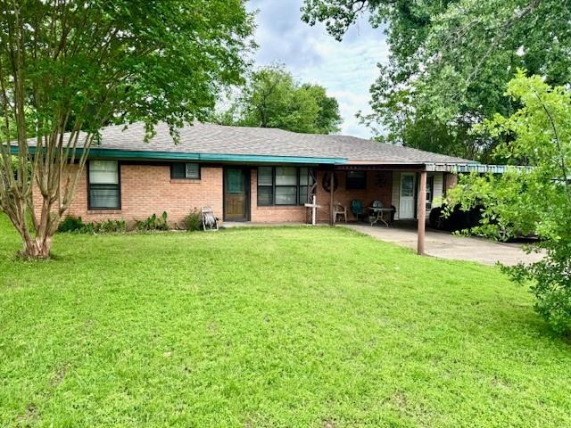 Brick exterior with a covered front porch and an attached carport