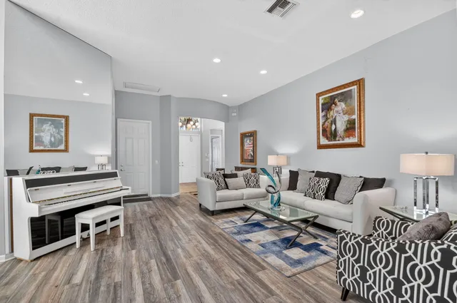 a view of a dining room with furniture wooden floor and chandelier