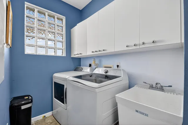 a view of a dining room with furniture a chandelier and wooden floor