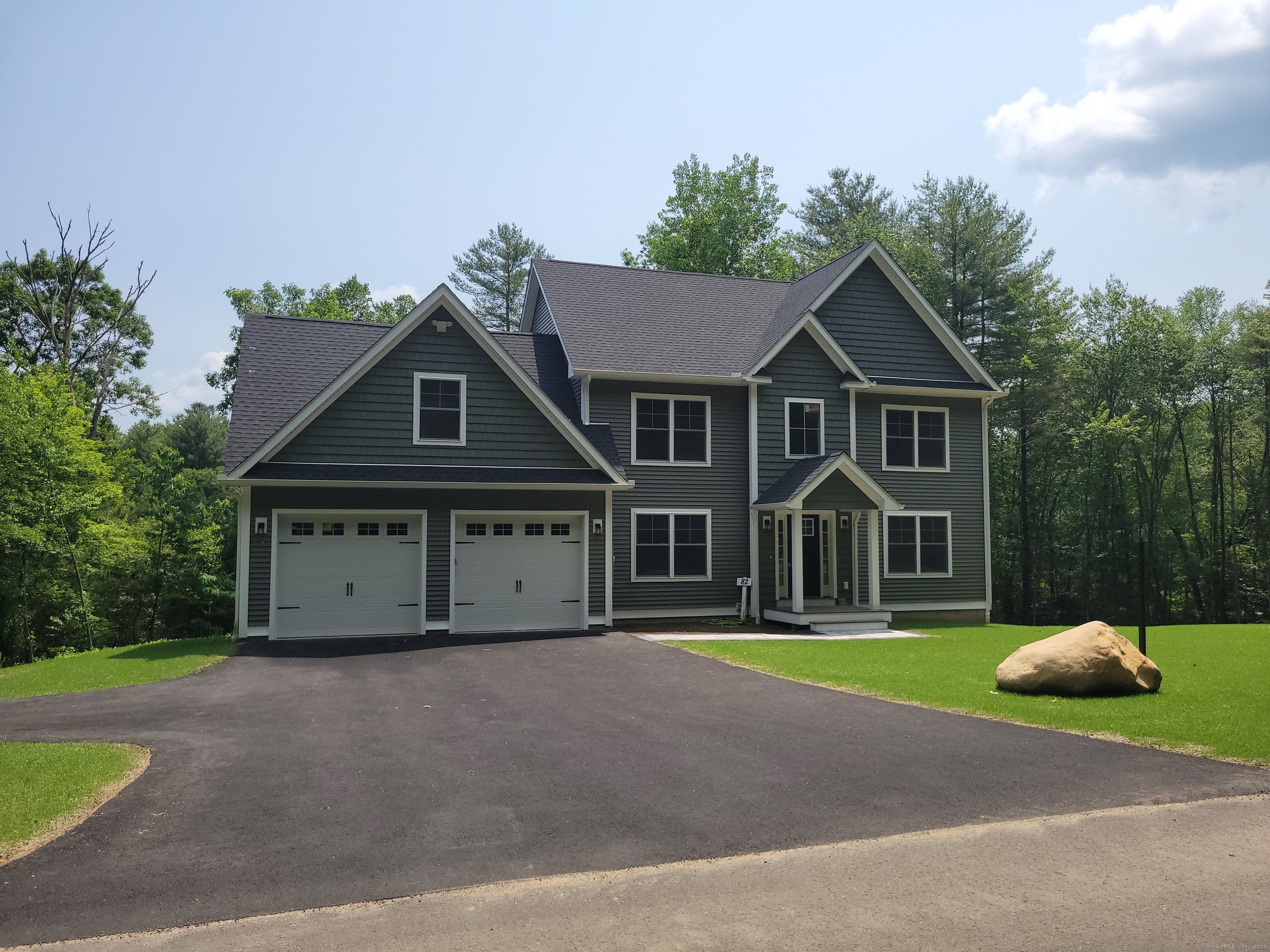 82 Ladd Road Tolland, CT 06084 - Photo 1 of 1 a front view of a house with a garden and trees