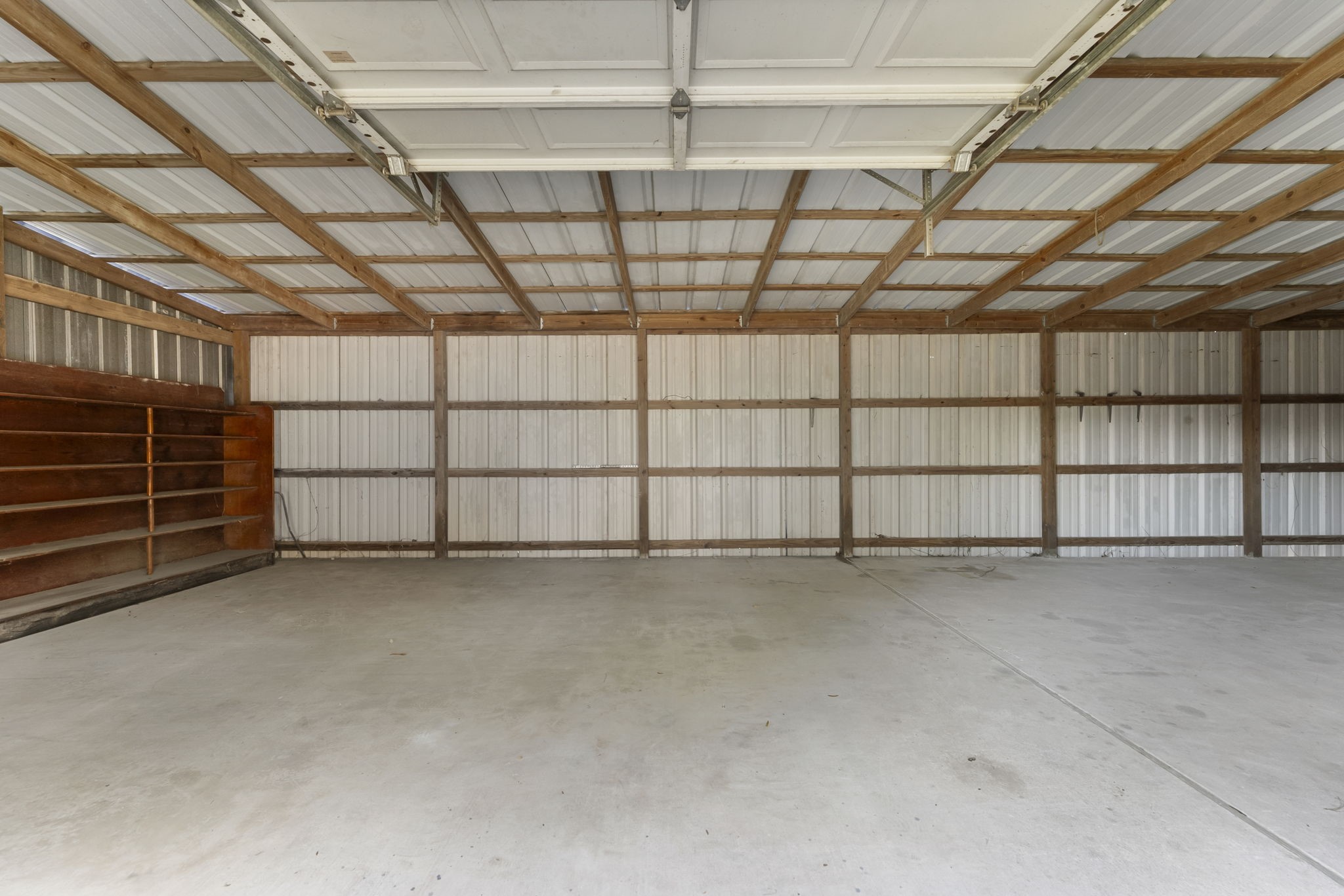 1635 Rayford Road Spring, TX 77386 - Photo 29 of 50 Interior of the secondary building Large shelving at each end will stay.