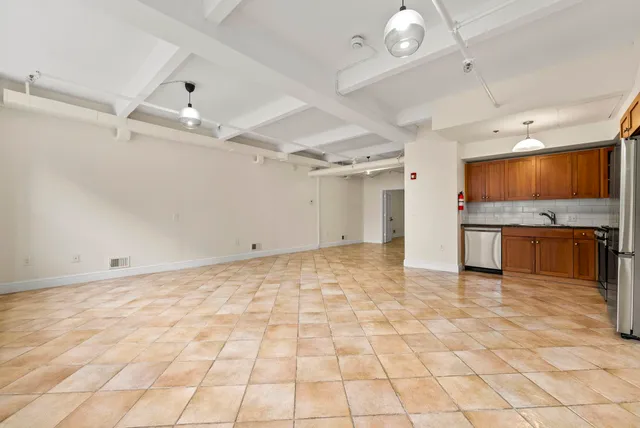 a view of a kitchen with a sink and cabinets