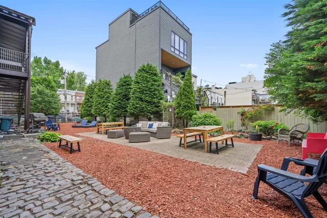 a view of a chairs and table in backyard
