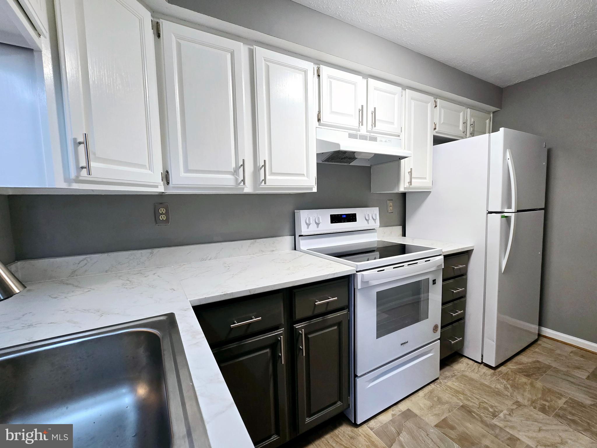 821 Stratford Way, Unit H Frederick, MD 21701 - Photo 13 of 45 a kitchen with a white cabinets and white appliances